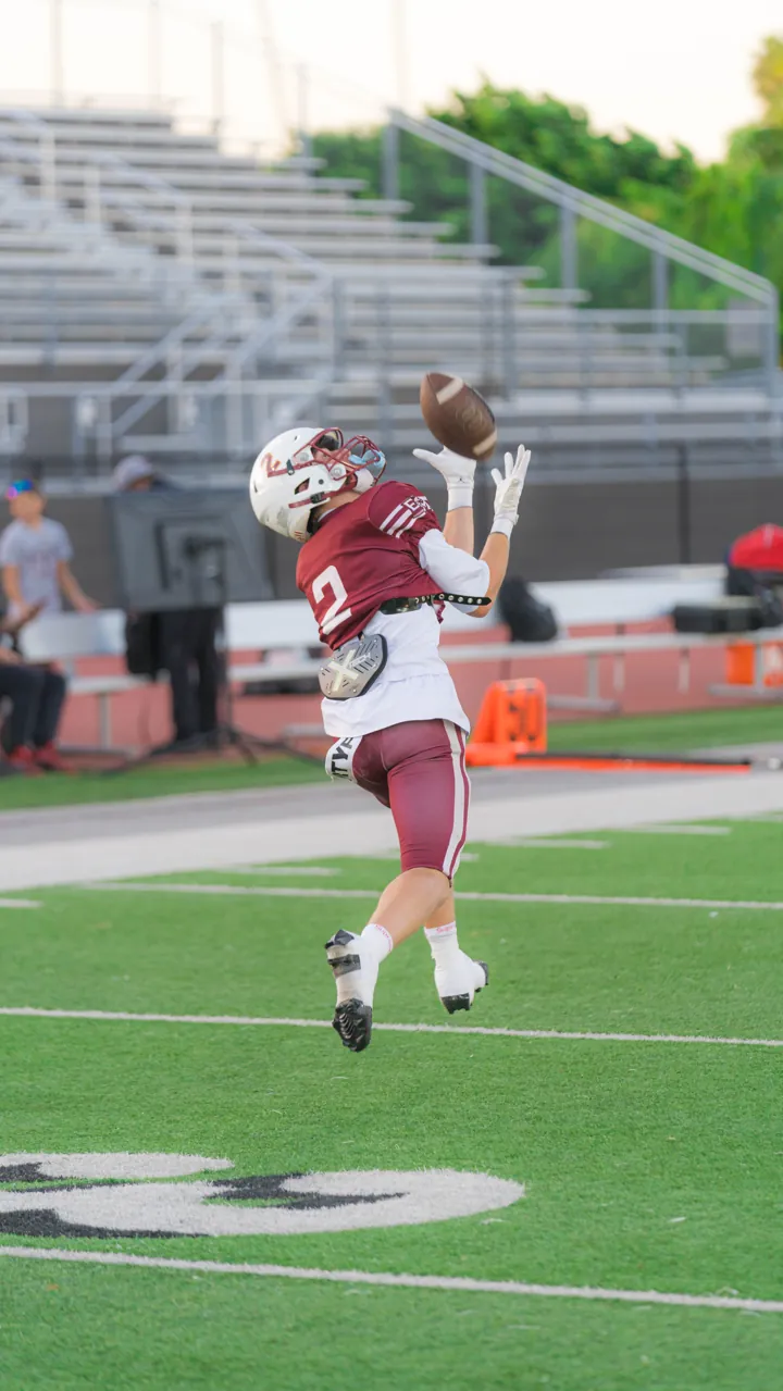 Receiver leaping for a catch near the sideline